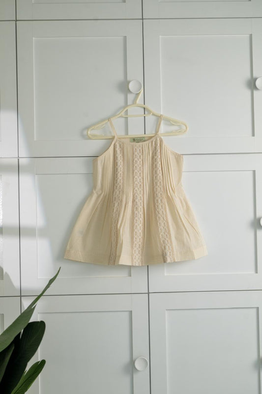 A soft, breathable cotton frock with delicate lace detailing and a cute flared fit
